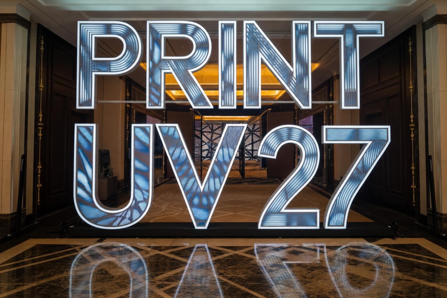Illustrative concept of giant mirrored PRINT UV 27 letters with glowing blue patterns standing in an elegant hotel corridor